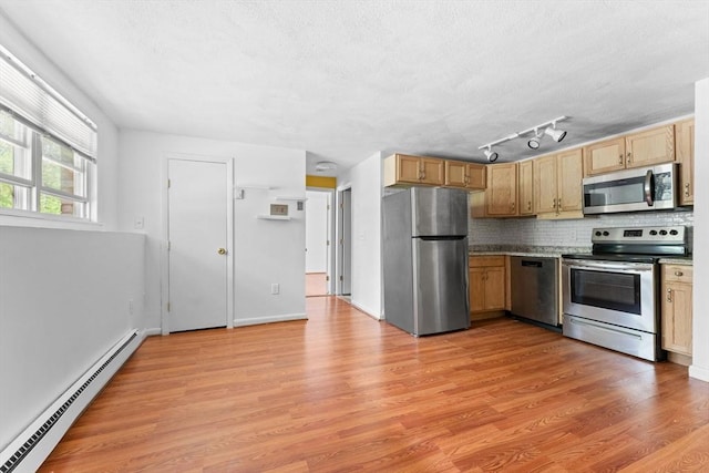 108 Oak Ln Unit 3, Brockton, MA 02301 - kitchen with appliances with stainless steel finishes, a baseboard heating unit, backsplash, and light wood-type flooring