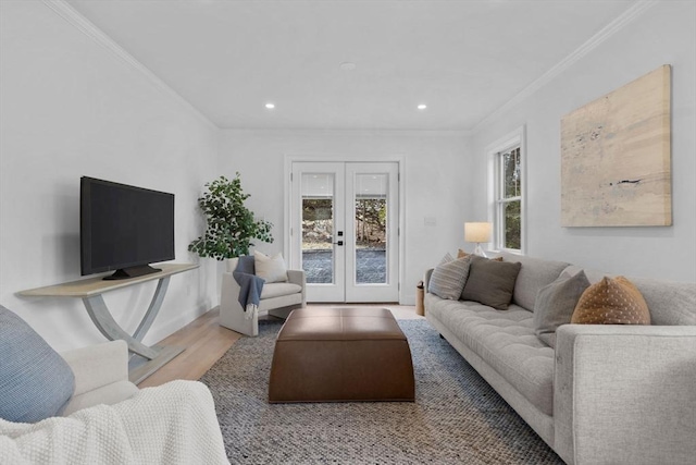 living area with wood finished floors, baseboards, recessed lighting, ornamental molding, and french doors