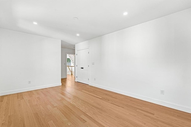 empty room with recessed lighting, baseboards, and light wood-style floors