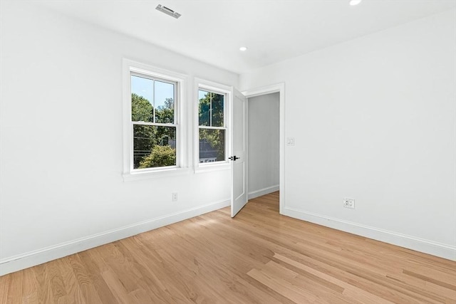 empty room featuring recessed lighting, visible vents, baseboards, and light wood-style floors