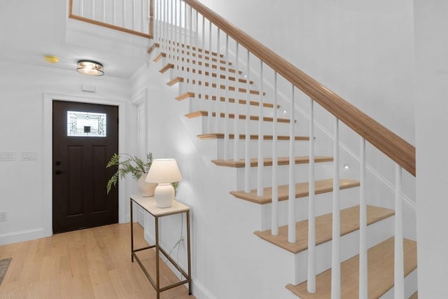 foyer featuring stairway and wood finished floors