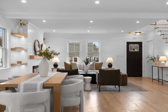 living area featuring stairway, plenty of natural light, recessed lighting, and light wood finished floors