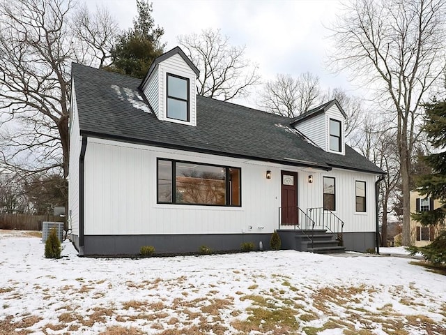 cape cod house featuring cooling unit