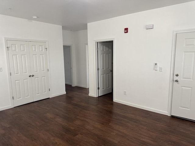 unfurnished room featuring dark wood-type flooring