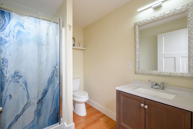 bathroom with vanity, wood-type flooring, toilet, and walk in shower