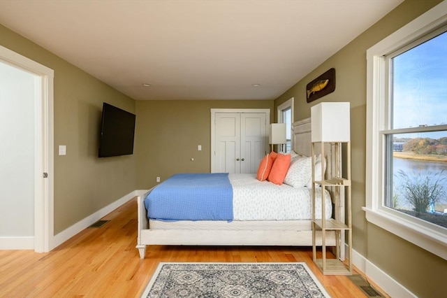 5 Oak Hill Rd, Wareham, MA 02571 - bedroom featuring baseboards, light wood-style flooring, a closet, and a water view