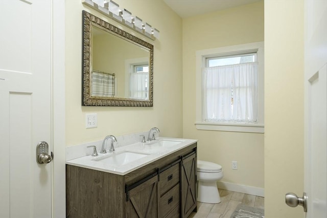 5 Oak Hill Rd, Wareham, MA 02571 - full bath with double vanity, toilet, baseboards, and wood finished floors