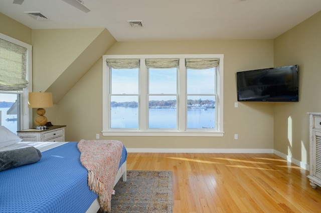 bedroom with light hardwood / wood-style floors and ceiling fan