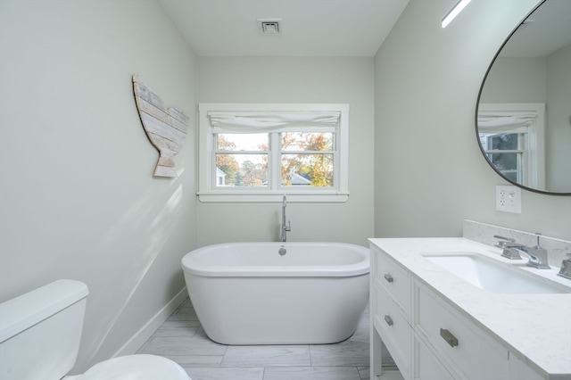 bathroom with vanity, toilet, and a bathing tub