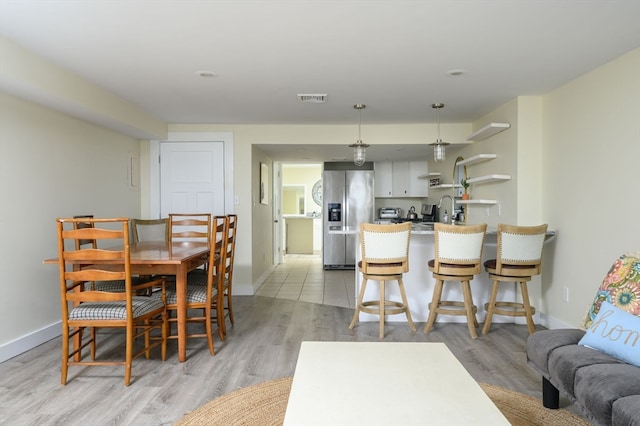 dining area featuring light hardwood / wood-style flooring and sink