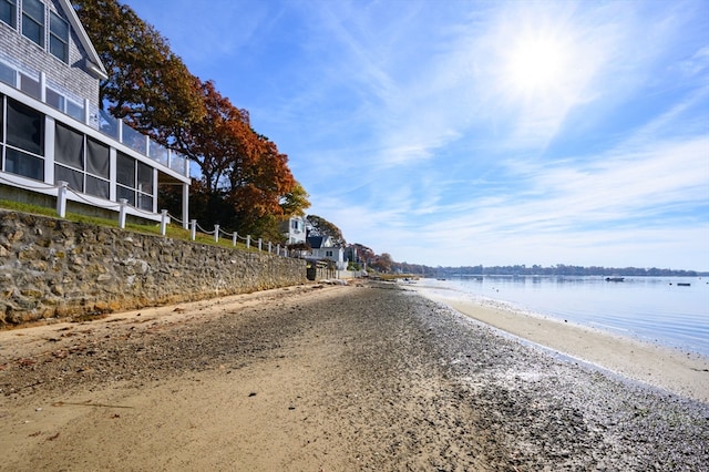 view of road with a view of the beach and a water view