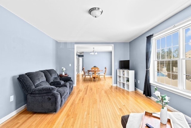 living room with hardwood / wood-style flooring and an inviting chandelier