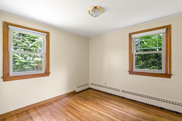 16 Sheldon Ave, Easthampton, MA 01027 - unfurnished room featuring a baseboard heating unit, healthy amount of natural light, ornamental molding, and light wood-style flooring