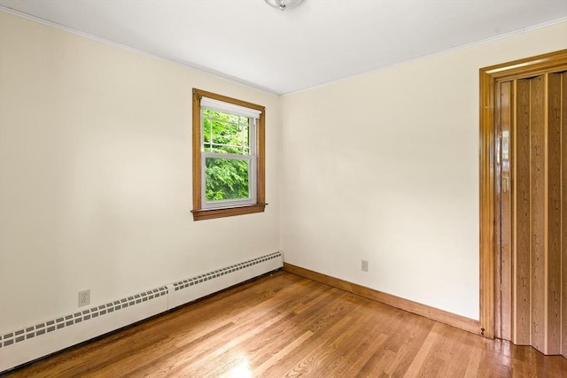 16 Sheldon Ave, Easthampton, MA 01027 - unfurnished room with a baseboard heating unit, ornamental molding, and wood finished floors