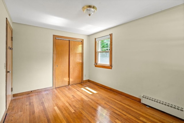 16 Sheldon Ave, Easthampton, MA 01027 - unfurnished bedroom featuring baseboard heating, light wood finished floors, and a closet