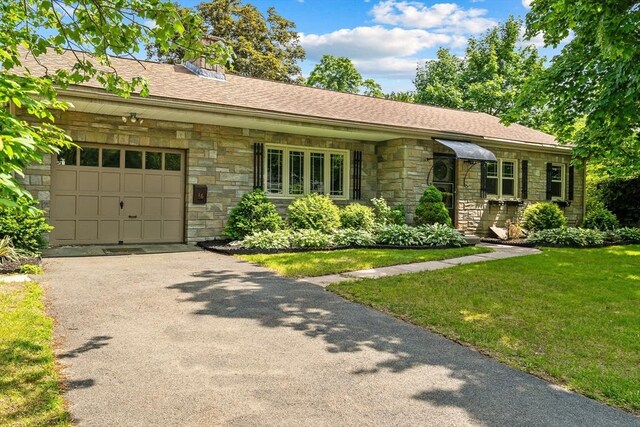16 Sheldon Ave, Easthampton, MA 01027 - ranch-style home with stone siding, a garage, driveway, and a front yard