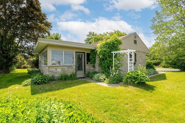 16 Sheldon Ave, Easthampton, MA 01027 - view of front of home with stone siding and a front lawn