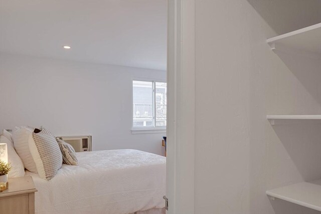 bedroom featuring a wall unit AC