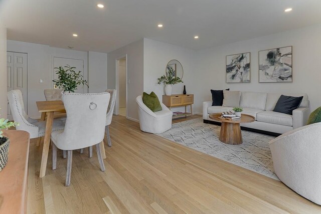 living area with recessed lighting and light wood-style flooring