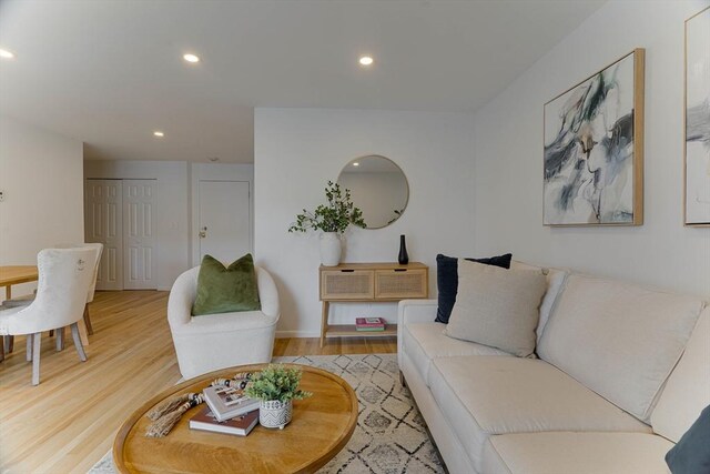 living area featuring recessed lighting and light wood-style flooring