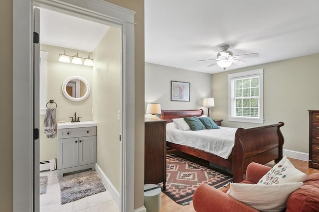 6 Lous Dr, Dudley, MA 01571 - bedroom featuring a baseboard heating unit, ensuite bath, and ceiling fan