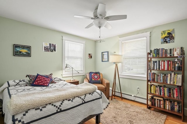6 Lous Dr, Dudley, MA 01571 - bedroom featuring baseboard heating, wood finished floors, and a ceiling fan