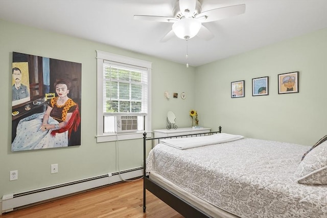 6 Lous Dr, Dudley, MA 01571 - bedroom featuring a baseboard radiator, cooling unit, light wood-style floors, and a ceiling fan