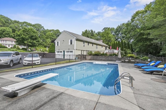6 Lous Dr, Dudley, MA 01571 - view of swimming pool with a diving board, view of wooded area, and a patio