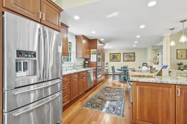 6 Lous Dr, Dudley, MA 01571 - kitchen featuring stainless steel appliances, light wood-type flooring, brown cabinetry, and recessed lighting
