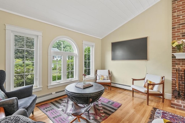 6 Lous Dr, Dudley, MA 01571 - living area with a baseboard radiator, vaulted ceiling, wood finished floors, and crown molding