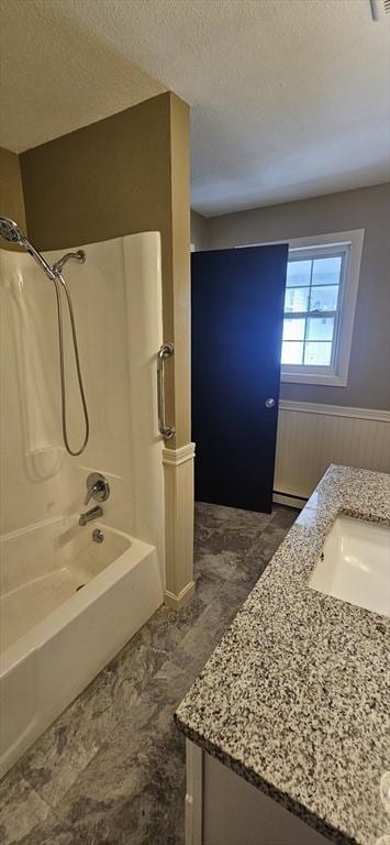 1 Wysocki Dr Unit 9, Dudley, MA 01571 - bathroom with vanity, a textured ceiling, shower / tub combination, and wainscoting