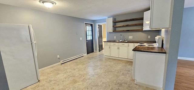 1 Wysocki Dr Unit 9, Dudley, MA 01571 - kitchen featuring white appliances, a baseboard heating unit, dark countertops, open shelves, and a sink