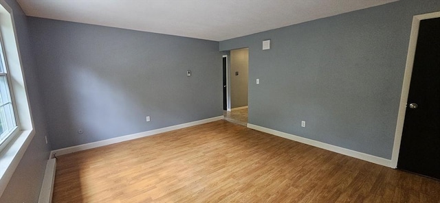 1 Wysocki Dr Unit 9, Dudley, MA 01571 - empty room with wood finished floors, baseboards, and a baseboard radiator