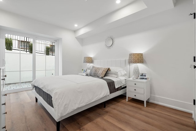 bedroom featuring access to exterior and light wood-type flooring