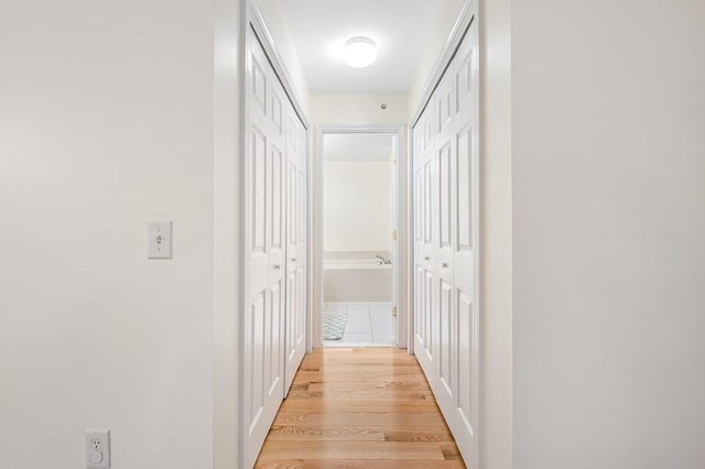 hallway with light wood-type flooring
