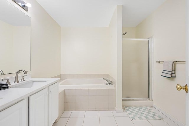 full bathroom featuring a stall shower, a garden tub, and vanity