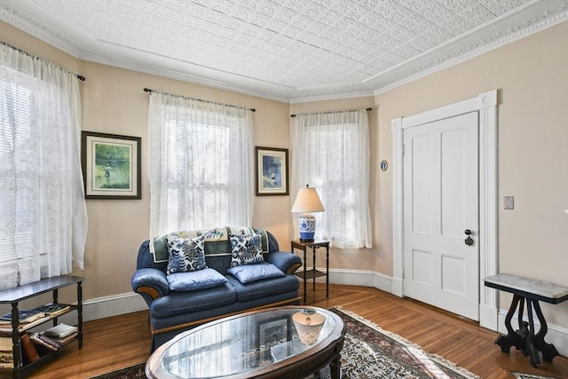 sitting room with crown molding and hardwood / wood-style flooring