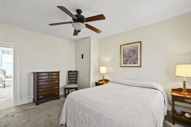 bedroom featuring ceiling fan, light colored carpet, and crown molding