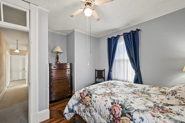 bedroom with a textured ceiling, dark parquet floors, ceiling fan, and ornamental molding