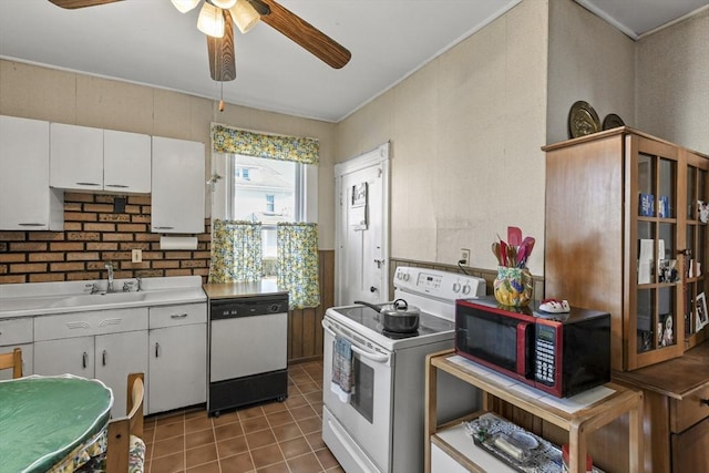 kitchen featuring white cabinetry, sink, ceiling fan, white appliances, and dark tile patterned flooring