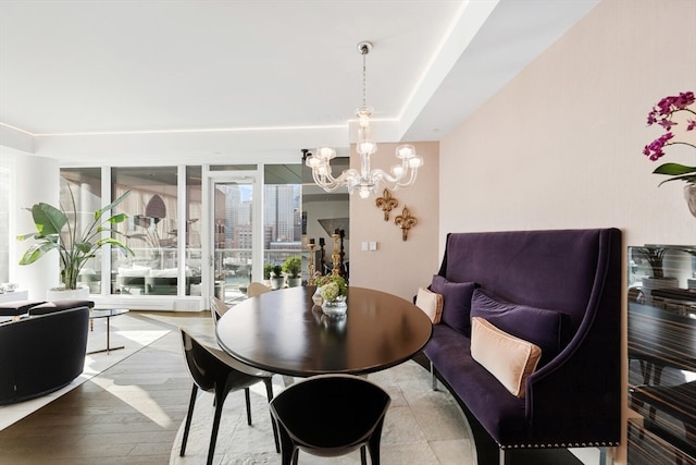 dining room featuring a notable chandelier and light hardwood / wood-style flooring