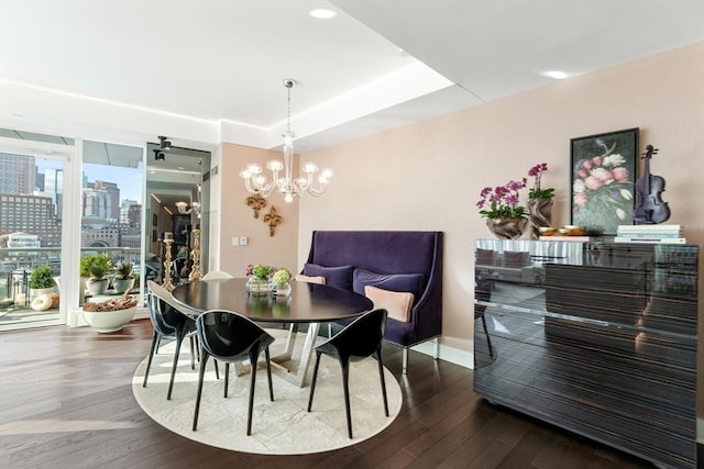 dining area featuring hardwood / wood-style flooring and a notable chandelier