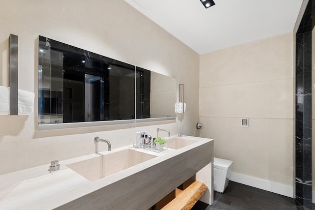 bathroom with hardwood / wood-style flooring, vanity, and toilet