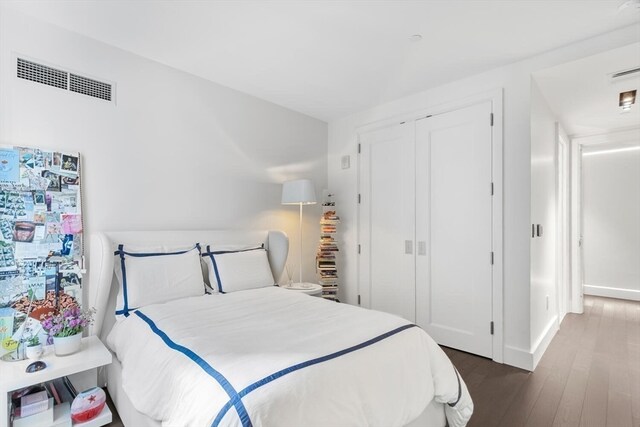 bedroom with a closet and dark hardwood / wood-style flooring