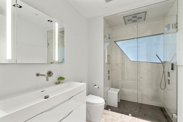 bathroom with walk in shower, vanity, toilet, and tile patterned floors