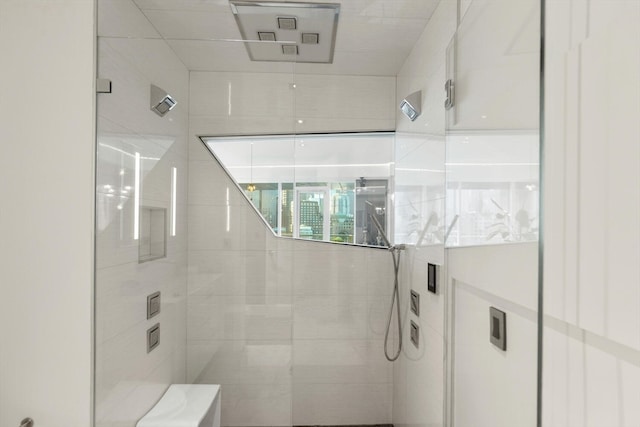 bathroom with tiled shower