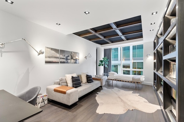 living room featuring coffered ceiling and hardwood / wood-style flooring