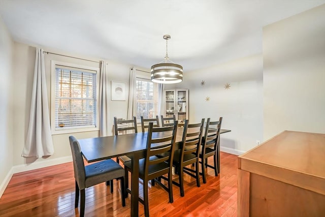 dining space featuring a healthy amount of sunlight, a chandelier, and hardwood / wood-style flooring