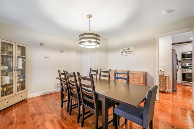 dining room featuring light hardwood / wood-style floors and an inviting chandelier