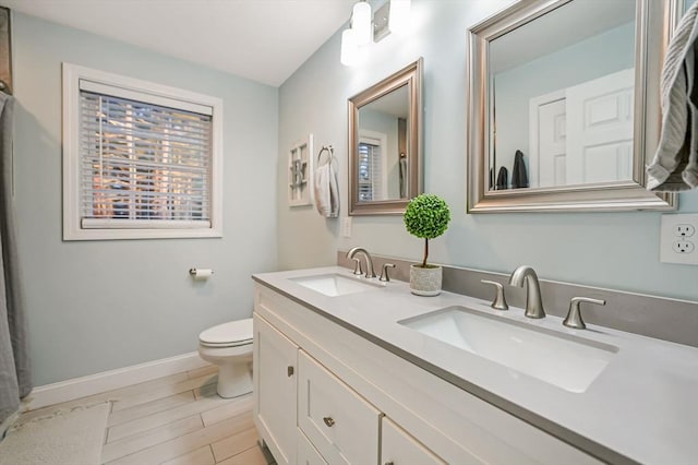 bathroom featuring toilet and vanity